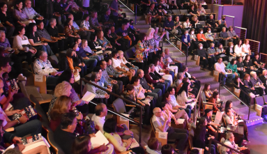 packed auditorium in the tateuchi forum, people of all ages
